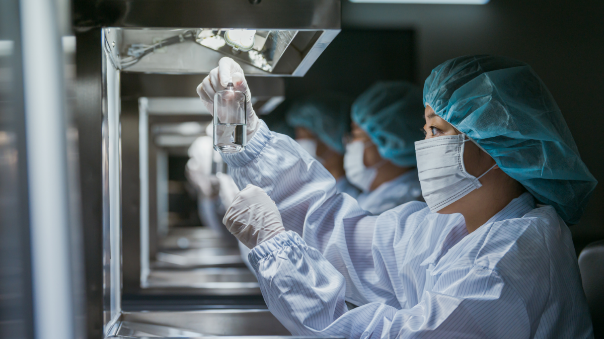 An employee carrying out the DP (Drug Product) manufacturing process.